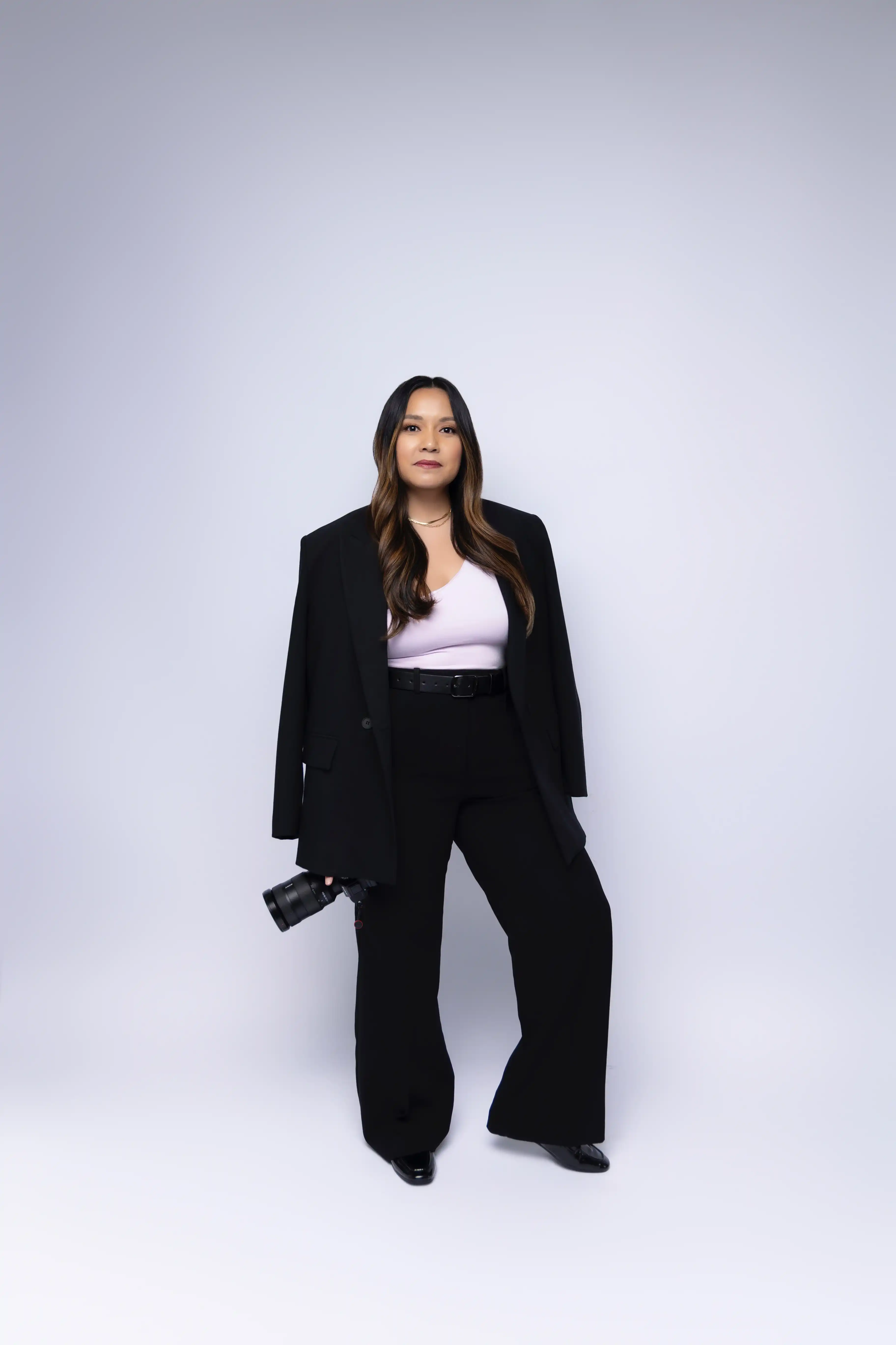 Darcelle holding a camera